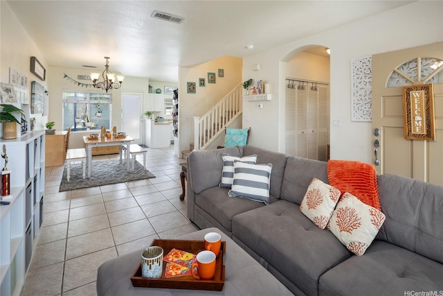 91-1121 Keoneula Blvd Unit L2, Ewa Beach, HI 96706 - living area with stairway, a chandelier, light tile patterned floors, and arched walkways