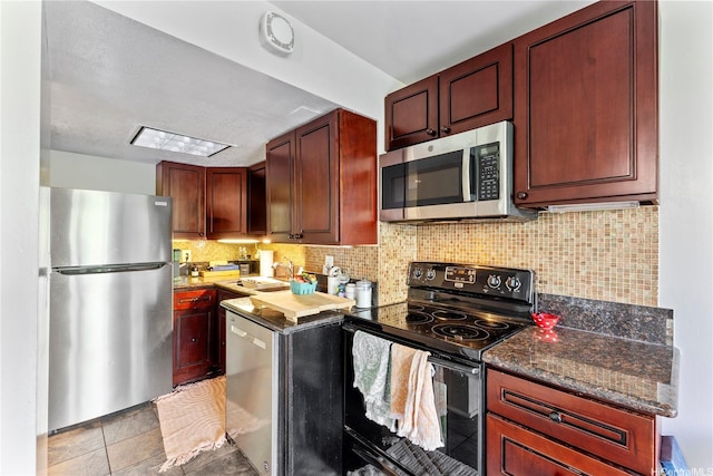 440 Seaside Ave Unit 404, Honolulu, HI 96815 - kitchen featuring appliances with stainless steel finishes, backsplash, reddish brown cabinets, and dark stone counters