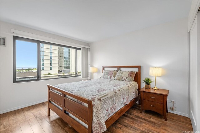 bedroom featuring wood finished floors and baseboards