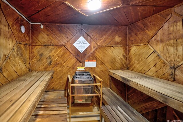 relaxing sauna / steam room with wooden ceiling, wood-type flooring, and wood walls