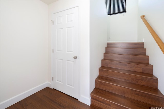 staircase with wood finished floors and baseboards