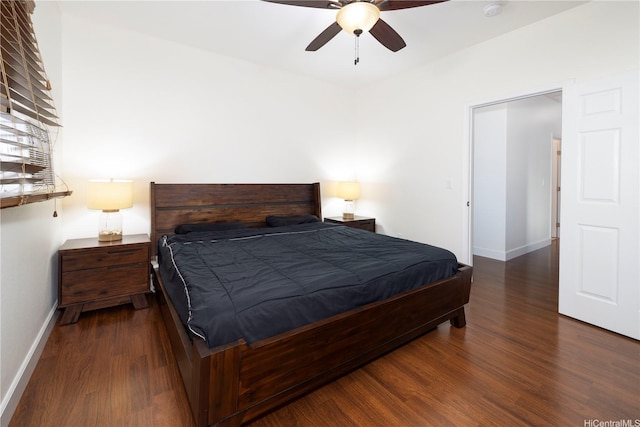 bedroom featuring wood finished floors, baseboards, and a ceiling fan