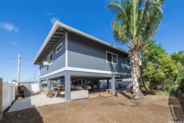 rear view of house featuring fence, a patio area, and a carport