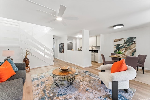 94-78 Aaahi Pl, Mililani, HI 96789 - living area with stairway, light wood-style flooring, ceiling fan, and baseboards