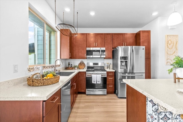 91-3390 Maohiohi Loop, Ewa Beach, HI 96706 - kitchen featuring appliances with stainless steel finishes, a sink, light wood-style floors, decorative light fixtures, and recessed lighting