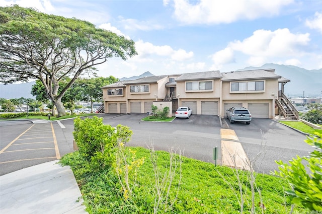46-010 Aliikane Pl Unit 211, Kaneohe, HI 96744 - view of front of home with stucco siding, stairway, and a mountain view