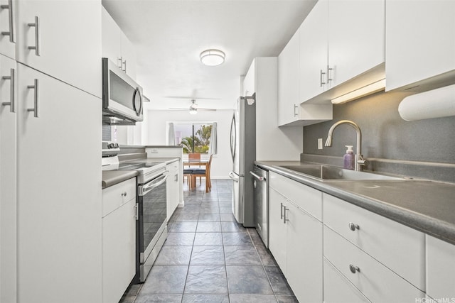 46-010 Aliikane Pl Unit 211, Kaneohe, HI 96744 - kitchen featuring appliances with stainless steel finishes, a sink, marble finish floors, ceiling fan, and white cabinets