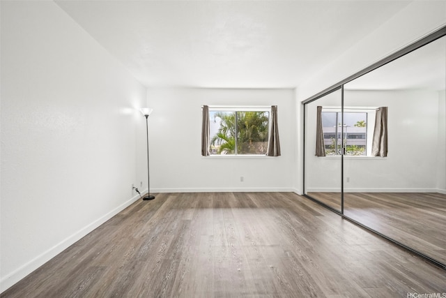 46-010 Aliikane Pl Unit 211, Kaneohe, HI 96744 - unfurnished bedroom with wood finished floors, baseboards, and a closet