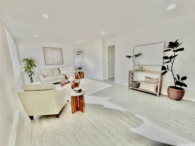 living area featuring wood finished floors, recessed lighting, and baseboards