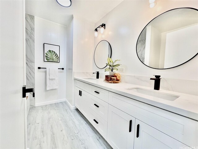 full bathroom featuring double vanity and wood finished floors
