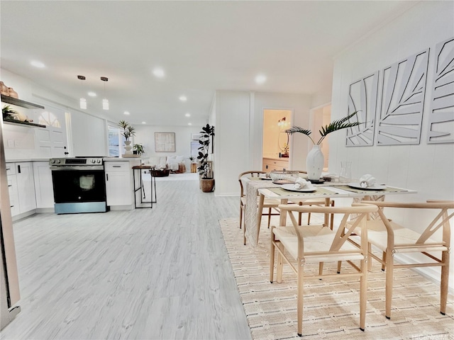 dining space featuring light wood-style floors and recessed lighting