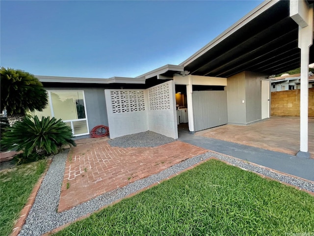 view of front of house with a patio area and fence
