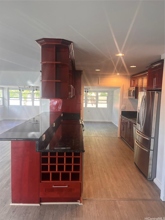45-342 Lehuuila St, Kaneohe, HI 96744 - kitchen featuring appliances with stainless steel finishes, dark countertops, light wood-type flooring, and baseboards
