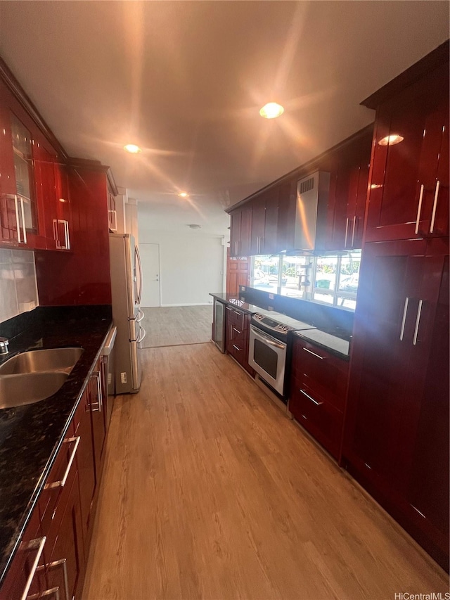45-342 Lehuuila St, Kaneohe, HI 96744 - kitchen with a sink, appliances with stainless steel finishes, light wood-style floors, glass insert cabinets, and reddish brown cabinets