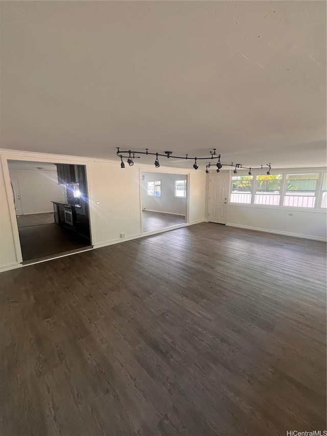 45-342 Lehuuila St, Kaneohe, HI 96744 - empty room with track lighting, baseboards, and dark wood-style flooring