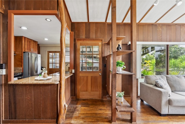 18 Dole Rd, Wahiawa, HI 96786 - interior space featuring freestanding refrigerator, wood finished floors, wooden walls, light stone countertops, and brown cabinetry