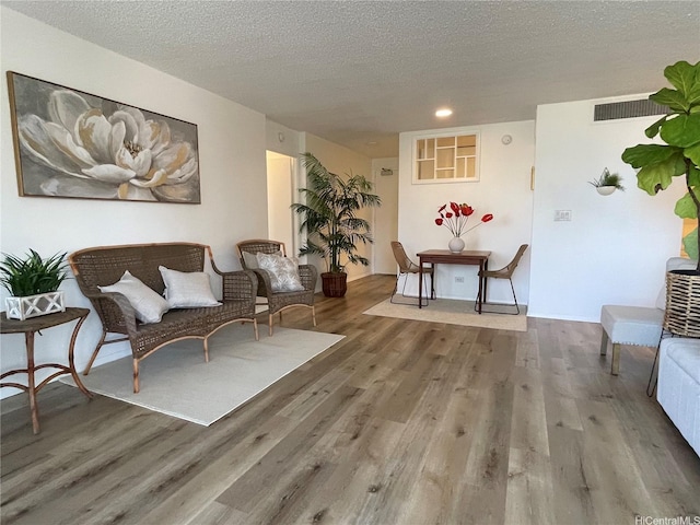 1561 Kanunu St Unit 1206, Honolulu, HI 96814 - living area with wood finished floors, a textured ceiling, and recessed lighting