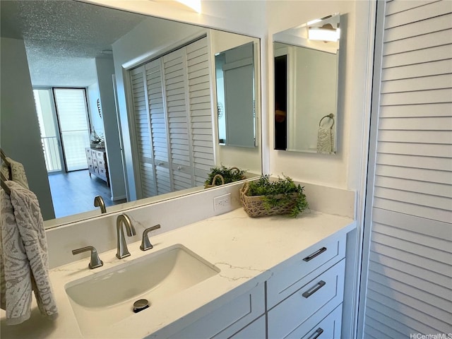 1561 Kanunu St Unit 1206, Honolulu, HI 96814 - bathroom featuring a textured ceiling and vanity