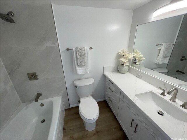 1561 Kanunu St Unit 1206, Honolulu, HI 96814 - bathroom with toilet, wood finished floors, vanity, and tub / shower combination