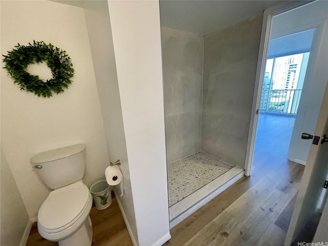 1561 Kanunu St Unit 1206, Honolulu, HI 96814 - full bathroom with wood finished floors, a shower stall, toilet, and baseboards