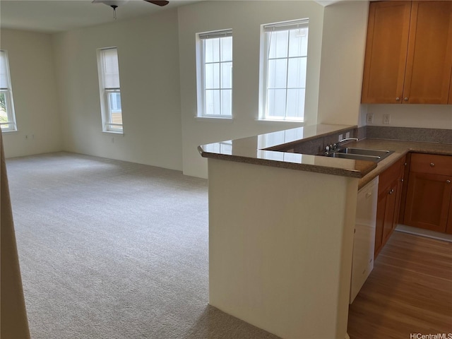 520 Lunalilo Home Rd Unit 7414, Honolulu, HI 96825 - kitchen featuring open floor plan, a peninsula, brown cabinetry, a sink, and carpet floors
