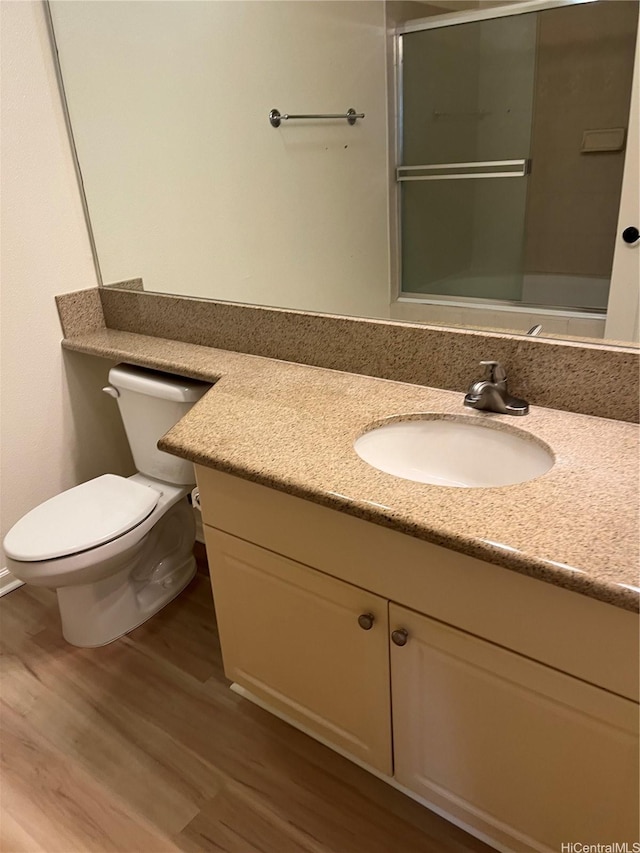 520 Lunalilo Home Rd Unit 7414, Honolulu, HI 96825 - full bathroom with wood finished floors, vanity, toilet, and a shower with shower door