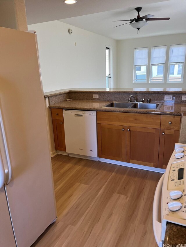 520 Lunalilo Home Rd Unit 7414, Honolulu, HI 96825 - kitchen with white appliances, a sink, brown cabinetry, and light wood-type flooring