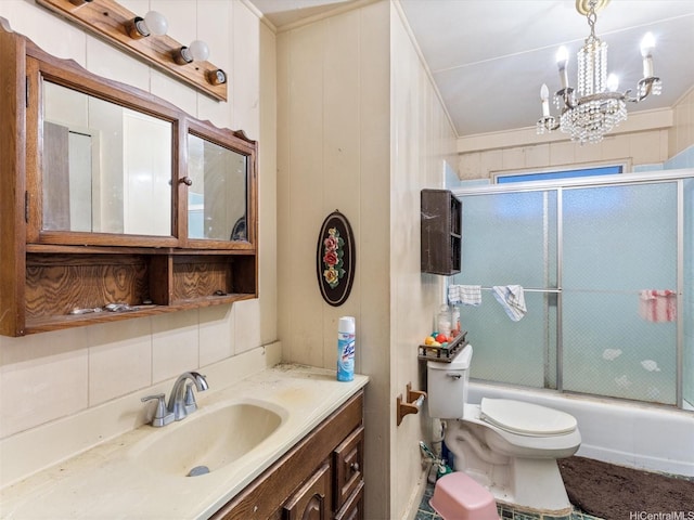 full bathroom with a chandelier, toilet, tasteful backsplash, combined bath / shower with glass door, and vanity