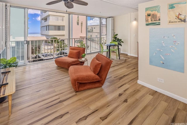 2801 Coconut Ave Unit 2G, Honolulu, HI 96815 - living area with wood finished floors, baseboards, a ceiling fan, and expansive windows