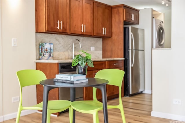 2801 Coconut Ave Unit 2G, Honolulu, HI 96815 - kitchen with freestanding refrigerator, washer / clothes dryer, baseboards, and light wood finished floors