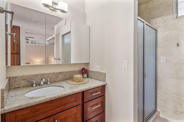 2801 Coconut Ave Unit 2G, Honolulu, HI 96815 - bathroom with a shower stall, vanity, and a textured ceiling