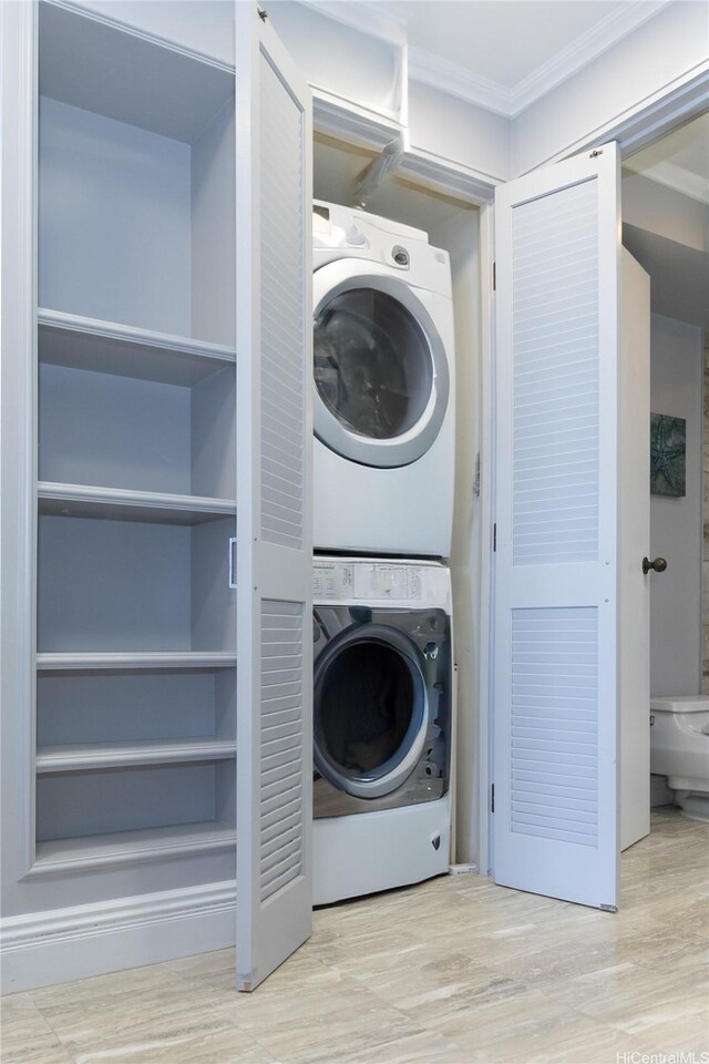 415 S St Unit 2902, Honolulu, HI 96813 - laundry room with stacked washing machine and dryer, crown molding, and wood finished floors
