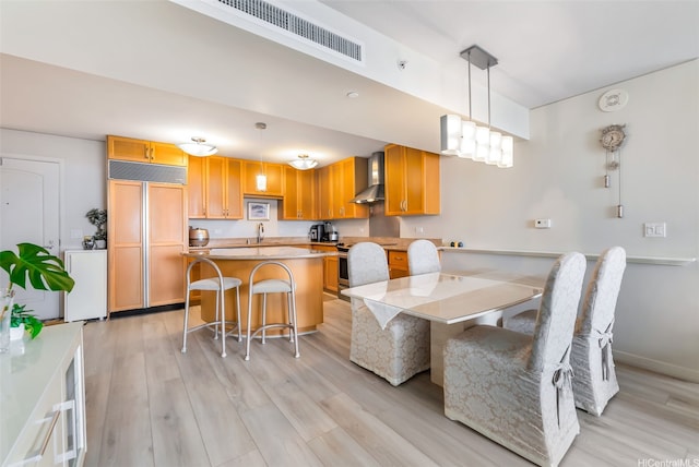 dining area with light wood-style floors and baseboards