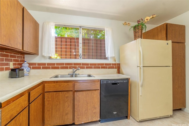 92-1044 Kanehoa Loop Unit 84, Kapolei, HI 96707 - kitchen with black dishwasher, freestanding refrigerator, a sink, light countertops, and decorative backsplash