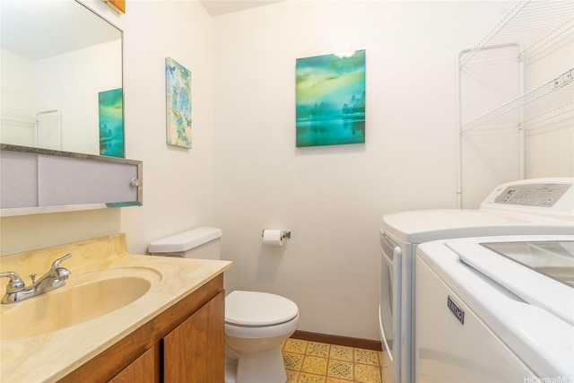 92-1044 Kanehoa Loop Unit 84, Kapolei, HI 96707 - bathroom with washing machine and dryer, baseboards, toilet, tile patterned floors, and vanity