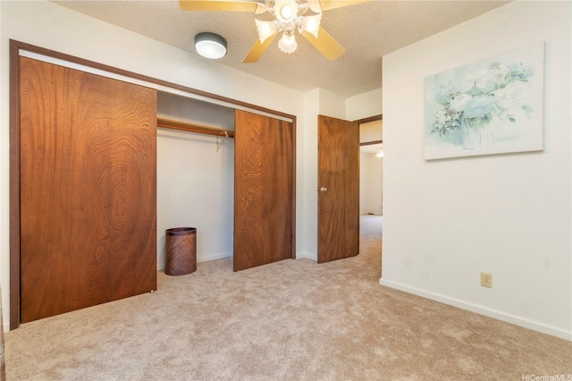 92-1044 Kanehoa Loop Unit 84, Kapolei, HI 96707 - unfurnished bedroom featuring a closet, carpet flooring, a textured ceiling, ceiling fan, and baseboards