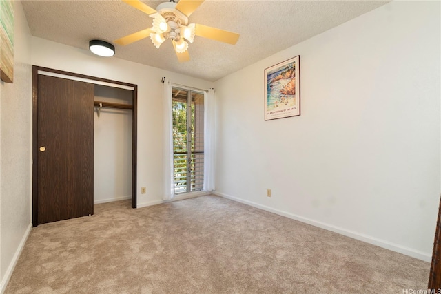 92-1044 Kanehoa Loop Unit 84, Kapolei, HI 96707 - unfurnished bedroom with a textured ceiling, carpet flooring, a closet, baseboards, and a ceiling fan