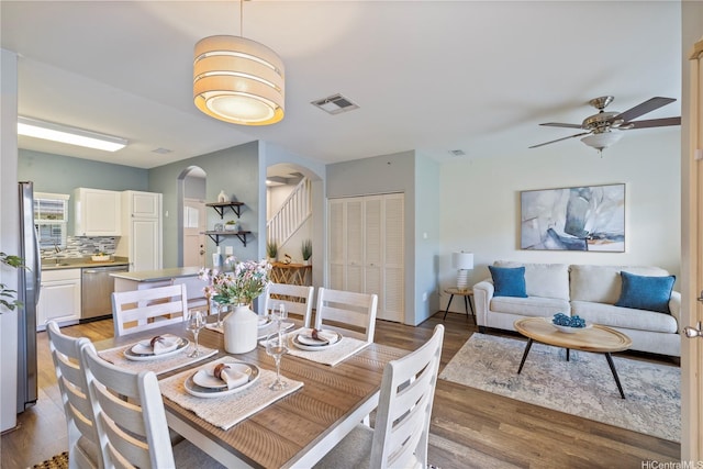 91-2125 Kaioli St Unit 3104, Ewa Beach, HI 96706 - dining room with arched walkways, light wood finished floors, and a ceiling fan