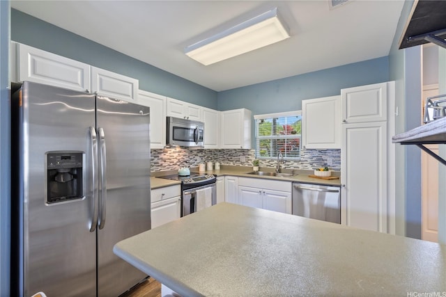 91-2125 Kaioli St Unit 3104, Ewa Beach, HI 96706 - kitchen featuring stainless steel appliances, white cabinets, tasteful backsplash, and light countertops