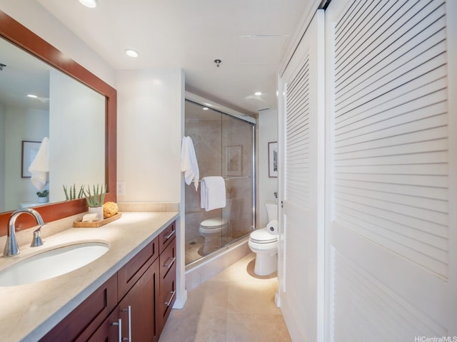 bathroom featuring toilet, a shower stall, vanity, tile patterned floors, and recessed lighting