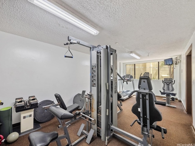 workout area featuring a textured ceiling