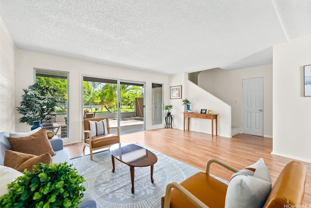 214 Koko Isle Cir Unit 1707, Honolulu, HI 96825 - living area featuring a textured ceiling, plenty of natural light, and wood finished floors
