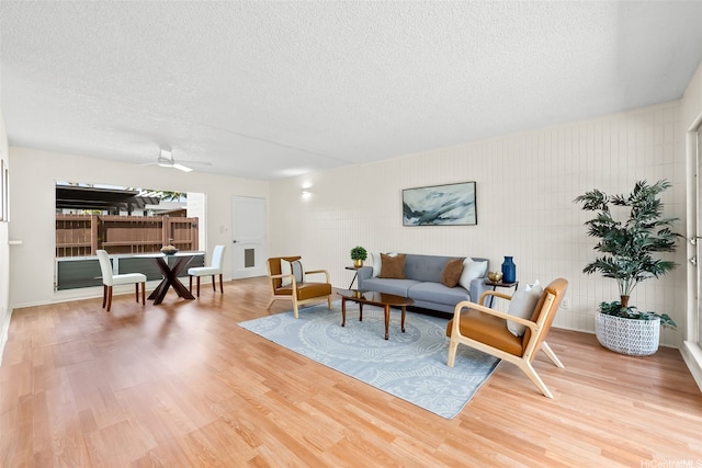 214 Koko Isle Cir Unit 1707, Honolulu, HI 96825 - living area with a textured ceiling, light wood-style flooring, and ceiling fan