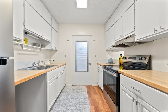 214 Koko Isle Cir Unit 1707, Honolulu, HI 96825 - kitchen with stainless steel appliances, wood counters, under cabinet range hood, light wood finished floors, and a sink