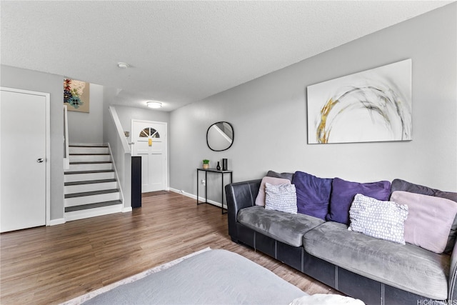 95-1049 Kuauli St Unit 49, Mililani, HI 96789 - living room featuring stairs, wood finished floors, baseboards, and a textured ceiling