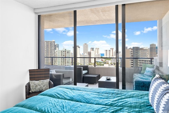581 Kamoku St Unit 2408, Honolulu, HI 96826 - bedroom featuring a view of skyline and a wall of windows