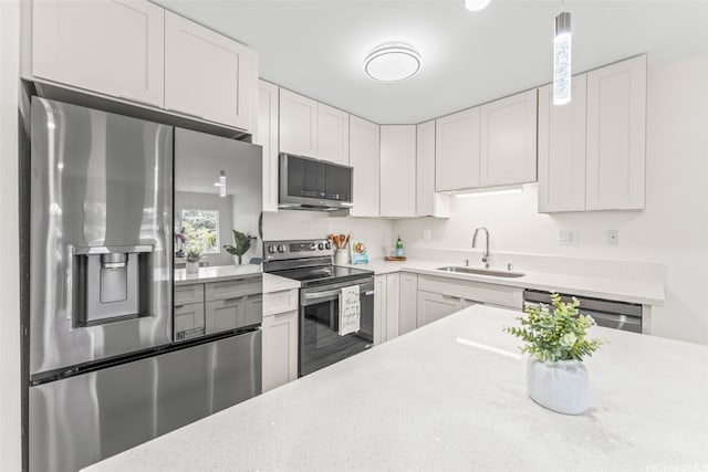 47-599 Alawiki St, Kaneohe, HI 96744 - kitchen with stainless steel appliances, a sink, white cabinetry, and hanging light fixtures