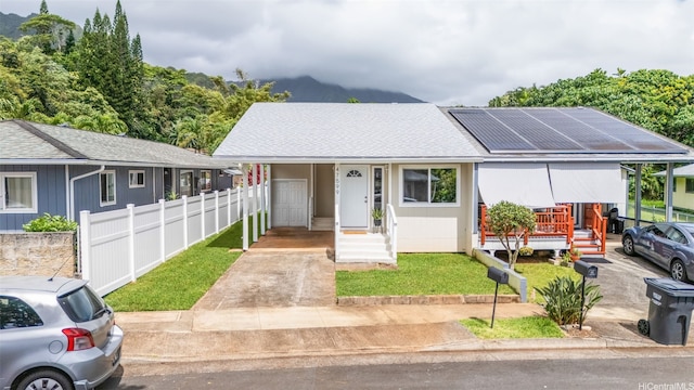 47-599 Alawiki St, Kaneohe, HI 96744 - view of front facade with driveway, roof with shingles, and roof mounted solar panels