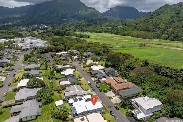 view of property location featuring a mountain backdrop and nearby suburban area