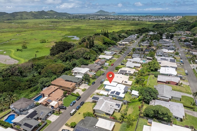 aerial view of property and surrounding area featuring nearby suburban area and a mountain backdrop